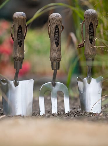 Three garden tools in a garden.